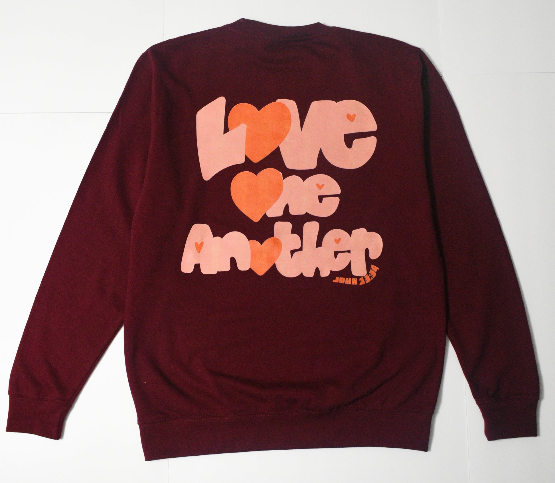 Back Side of Sweatshirt. Design has Words: Love One Another John 13:34